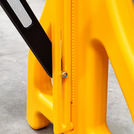 Yellow and black plastic expandable barrier.