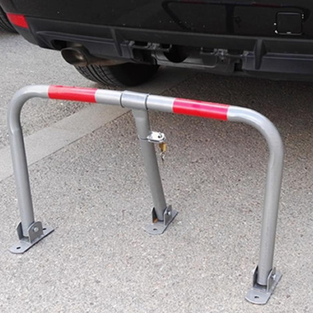 Economical parking barrier, gray with red reflectors.