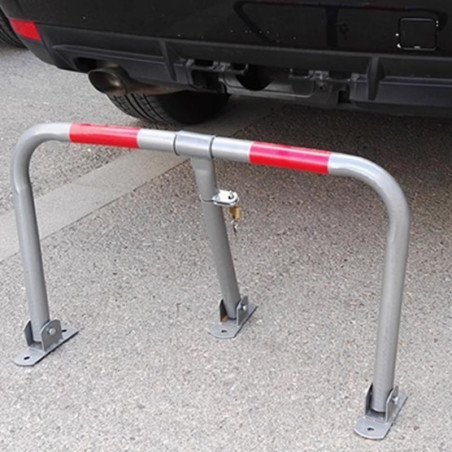 Economical parking barrier, gray with red reflectors.