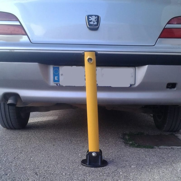 Folding parking barrier with lock. Yellow color.